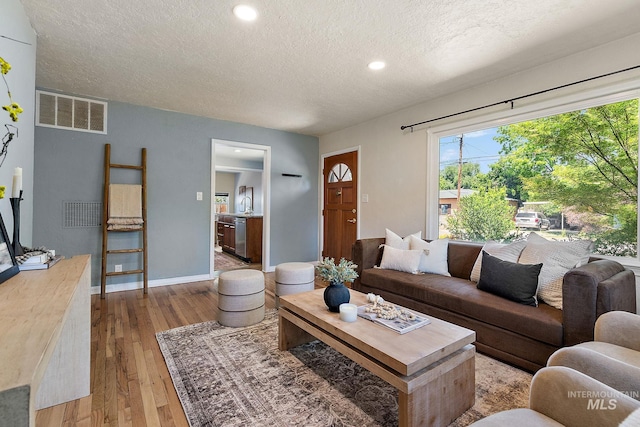 3209 W Plant Dr, Boise, ID 83703 - living room with a textured ceiling, hardwood / wood-style flooring, baseboards, and recessed lighting