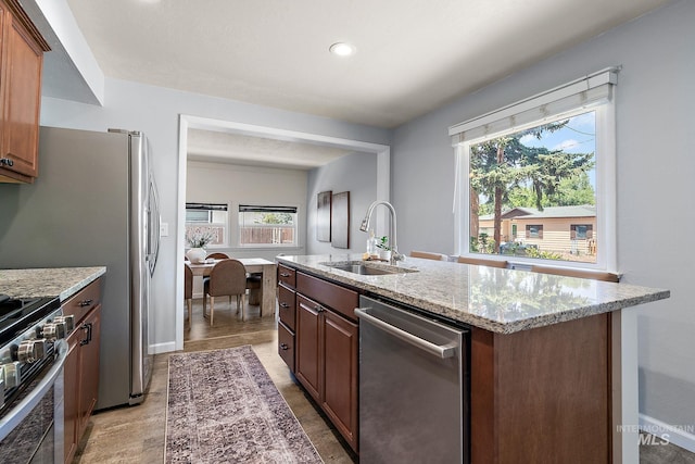 3209 W Plant Dr, Boise, ID 83703 - kitchen with stainless steel appliances, a sink, plenty of natural light, light stone countertops, and recessed lighting