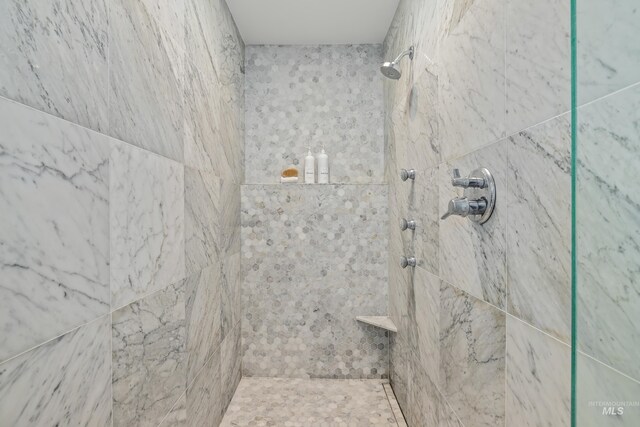 bathroom with tiled shower