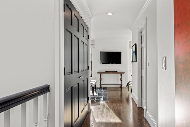 hallway with crown molding, baseboards, and dark wood-style flooring