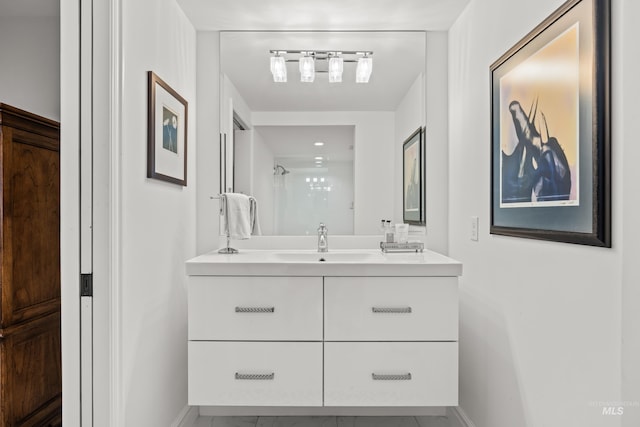 bathroom with walk in shower and vanity