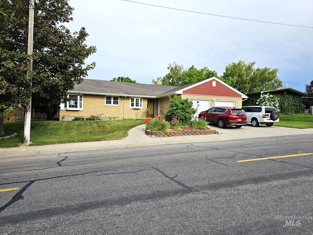 ranch-style house with a garage and a front lawn