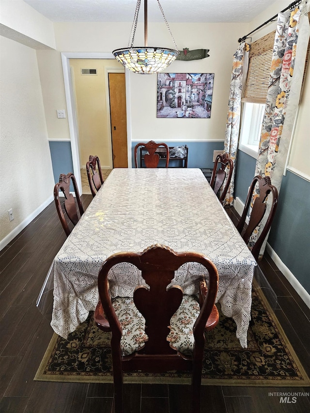 dining room with dark hardwood / wood-style flooring