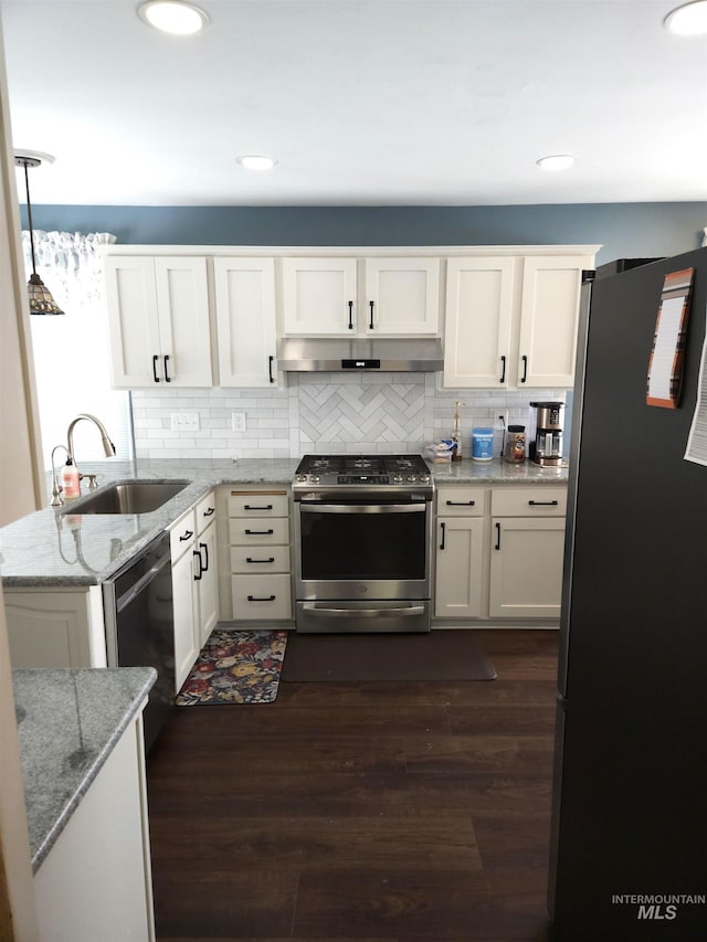 kitchen featuring tasteful backsplash, white cabinetry, sink, light stone counters, and stainless steel appliances