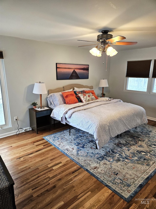 bedroom with ceiling fan and hardwood / wood-style floors