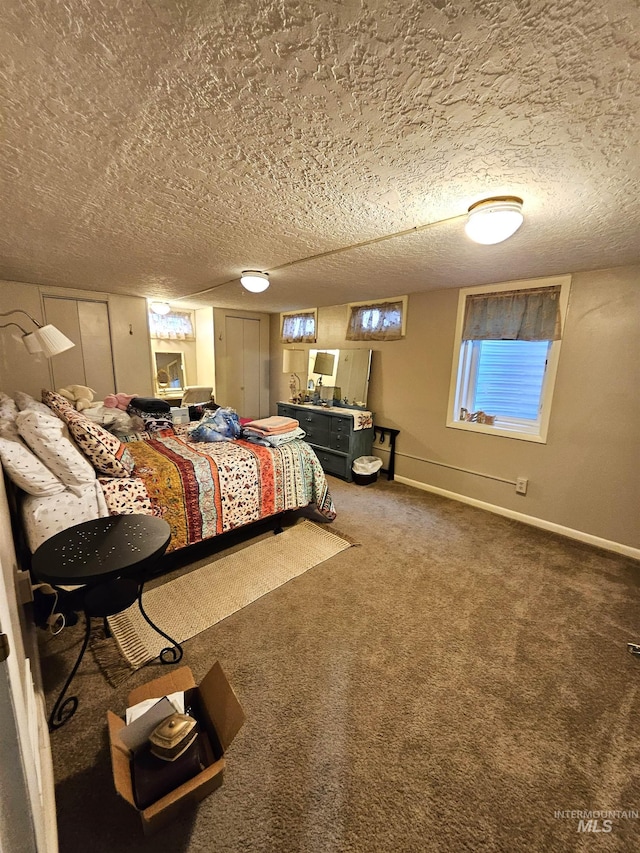 carpeted bedroom featuring a textured ceiling