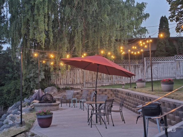 view of home's community featuring a patio area and a fire pit