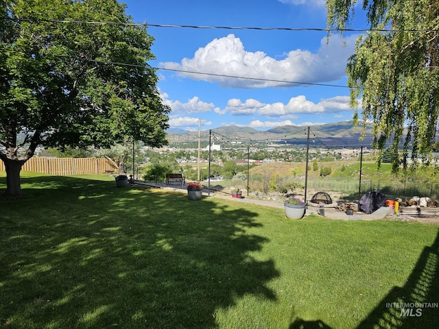 view of yard with an outdoor fire pit and a mountain view