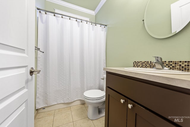 bathroom with tile patterned flooring, toilet, vanity, ornamental molding, and decorative backsplash