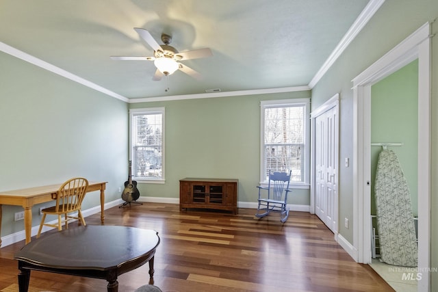 sitting room with baseboards, visible vents, wood finished floors, and ornamental molding