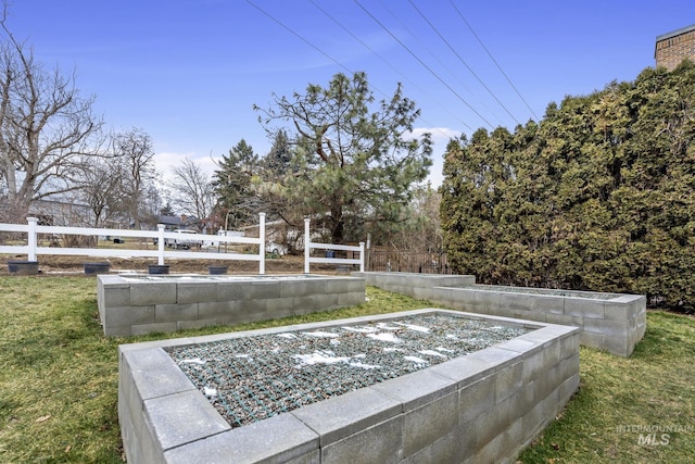 exterior space with fence and a garden