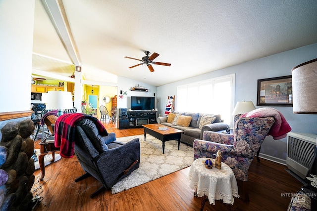 living area with lofted ceiling, ceiling fan, a textured ceiling, and wood finished floors