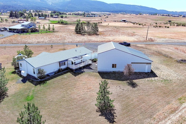 birds eye view of property featuring a mountain view and a rural view