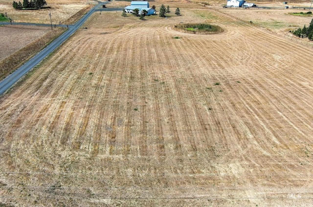 birds eye view of property with a rural view