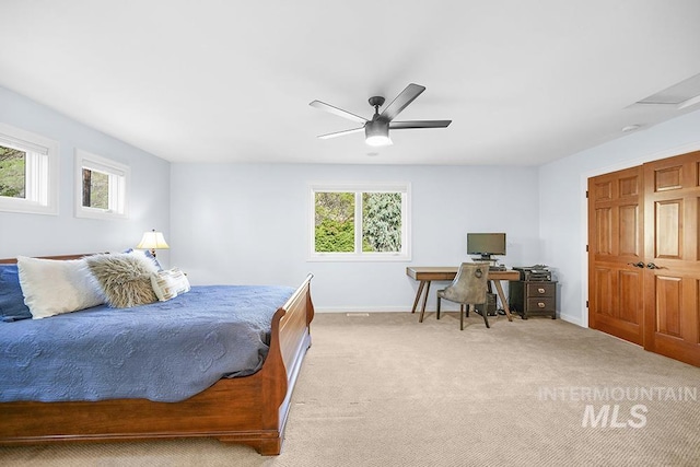 bedroom with baseboards, a ceiling fan, multiple windows, and light colored carpet