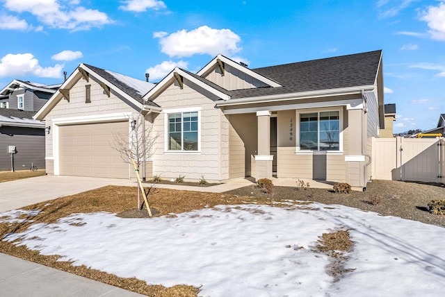 craftsman house featuring a gate, fence, an attached garage, concrete driveway, and board and batten siding