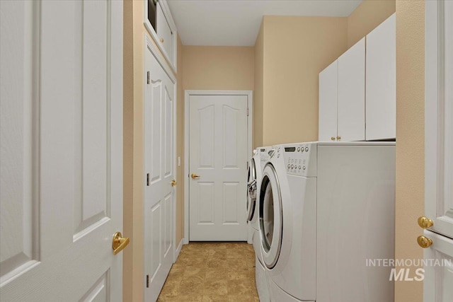 washroom with cabinet space and independent washer and dryer