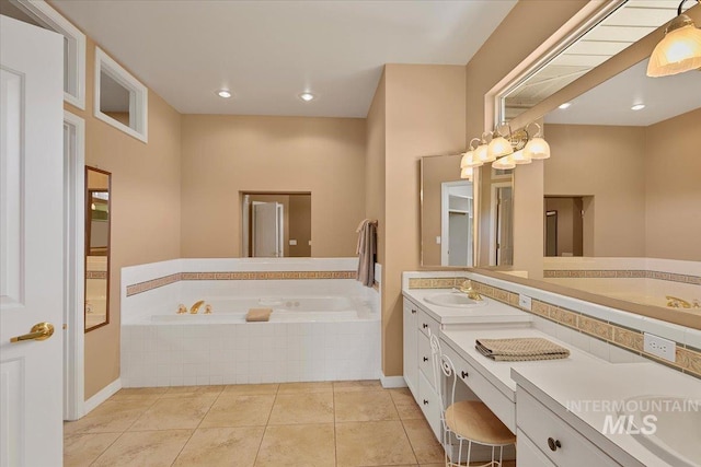 full bathroom with double vanity, a garden tub, tile patterned flooring, and a sink