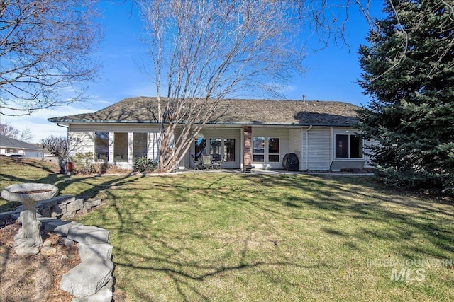 back of house featuring a lawn