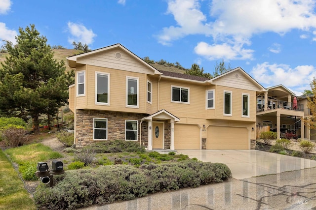 5873 N Collister Dr, Boise, ID 83703 - multi unit property featuring stone siding, an attached garage, driveway, and a balcony