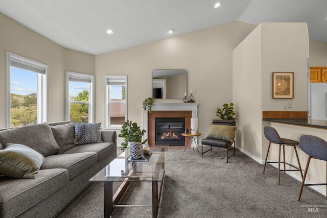 5873 N Collister Dr, Boise, ID 83703 - carpeted living area with plenty of natural light, a tiled fireplace, recessed lighting, vaulted ceiling, and baseboards