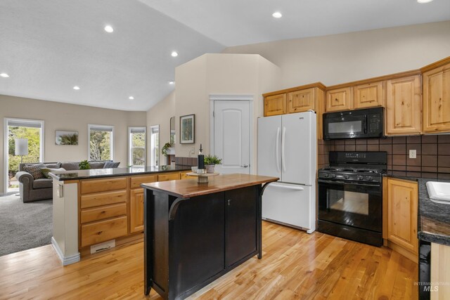 5873 N Collister Dr, Boise, ID 83703 - kitchen with black appliances, dark countertops, open floor plan, light wood finished floors, and backsplash