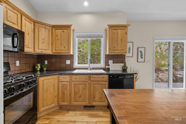 5873 N Collister Dr, Boise, ID 83703 - kitchen featuring black appliances, a sink, light wood-style floors, tasteful backsplash, and recessed lighting