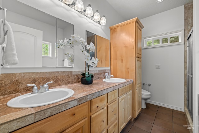 5873 N Collister Dr, Boise, ID 83703 - bathroom with toilet, tile patterned flooring, a shower stall, and double vanity