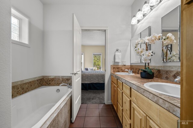 5873 N Collister Dr, Boise, ID 83703 - bathroom with tile patterned floors, a bath, ensuite bath, and double vanity
