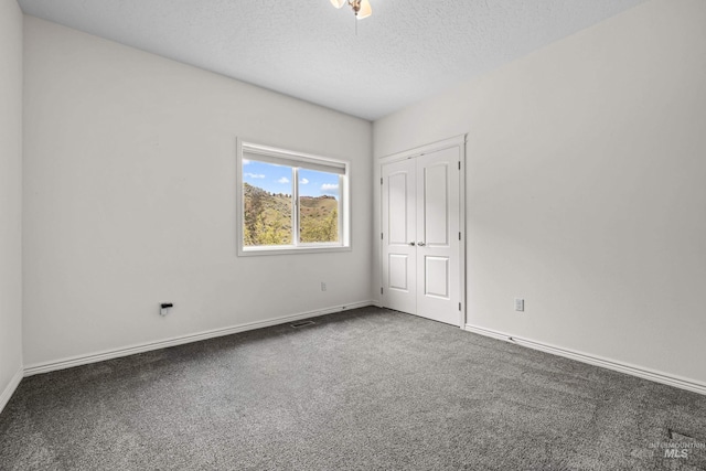 5873 N Collister Dr, Boise, ID 83703 - unfurnished bedroom featuring carpet floors, baseboards, a textured ceiling, and a closet