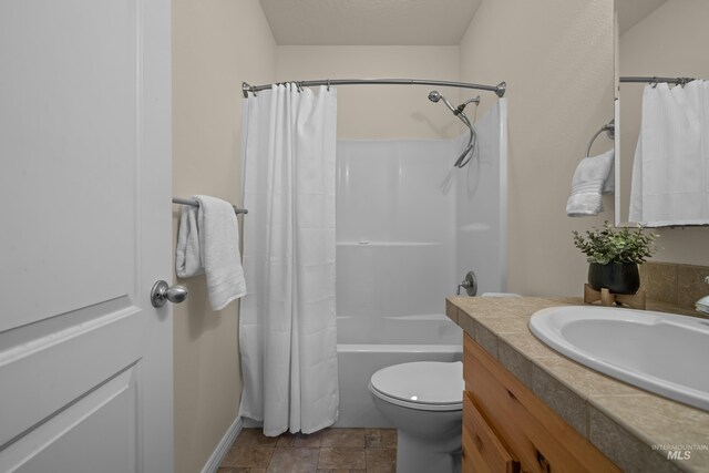 5873 N Collister Dr, Boise, ID 83703 - full bathroom featuring toilet, vanity, shower / bath combination with curtain, baseboards, and stone finish flooring