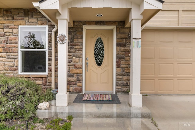 5873 N Collister Dr, Boise, ID 83703 - view of exterior entry featuring stone siding and an attached garage