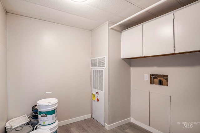 347 Winona Dr, Fairfield, ID 83327 - laundry area with cabinet space, baseboards, light wood finished floors, and washer hookup