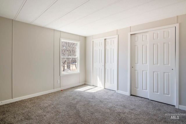 347 Winona Dr, Fairfield, ID 83327 - unfurnished bedroom with carpet flooring, baseboards, and multiple closets