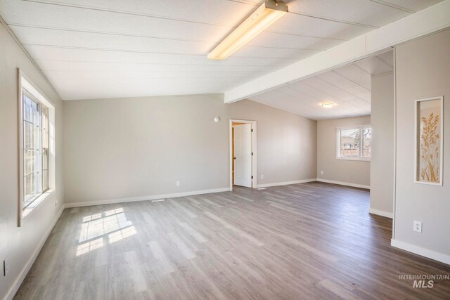 347 Winona Dr, Fairfield, ID 83327 - empty room featuring wood finished floors, lofted ceiling with beams, and baseboards