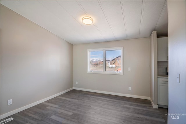 347 Winona Dr, Fairfield, ID 83327 - spare room featuring visible vents, dark wood-style flooring, and baseboards
