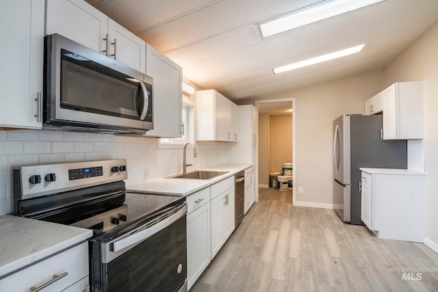 347 Winona Dr, Fairfield, ID 83327 - kitchen with light wood-type flooring, a sink, lofted ceiling, stainless steel appliances, and backsplash