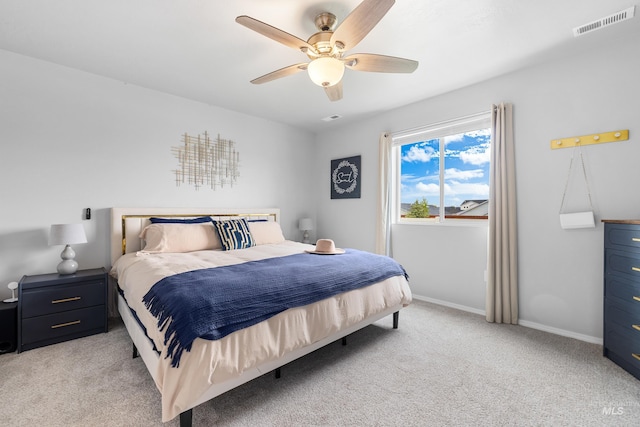 bedroom featuring baseboards, light carpet, a ceiling fan, and visible vents