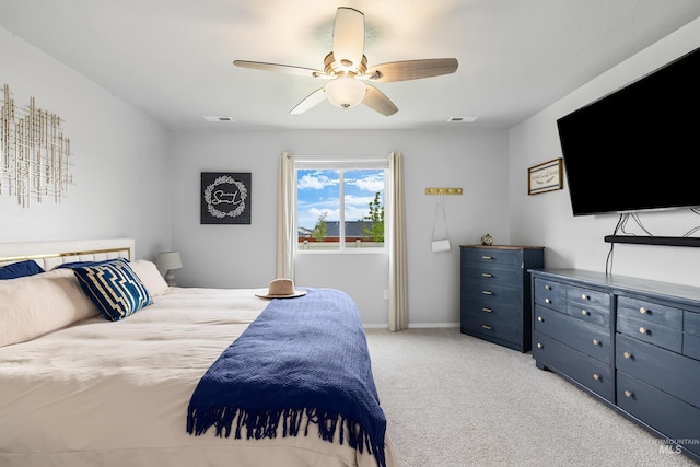 bedroom featuring ceiling fan, light colored carpet, and visible vents