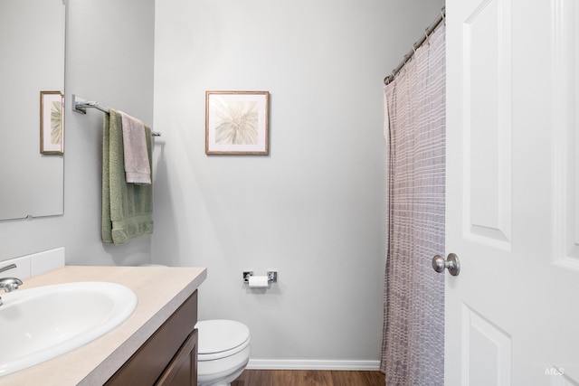 full bath featuring vanity, toilet, and wood finished floors