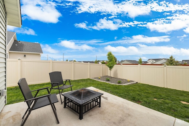 view of patio featuring a fenced backyard and an outdoor fire pit