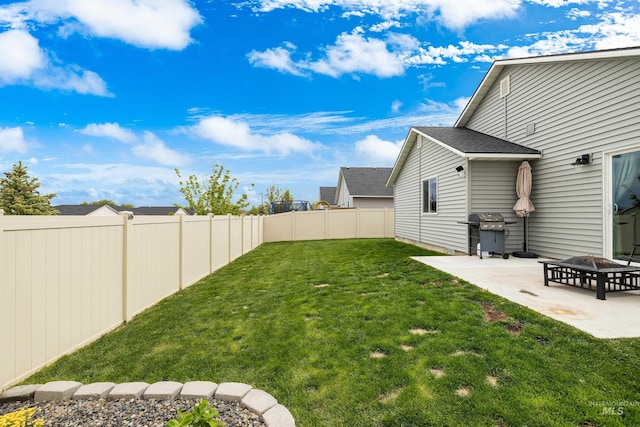 view of yard featuring a fenced backyard, a patio area, and an outdoor fire pit