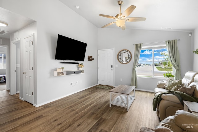 living room with ceiling fan, high vaulted ceiling, baseboards, wood finished floors, and visible vents