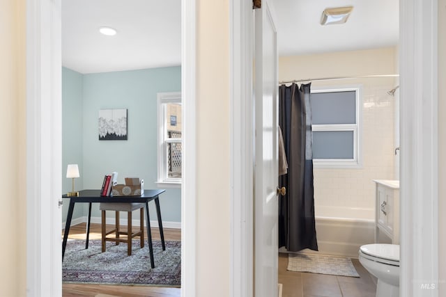 full bathroom with baseboards, shower / bath combo with shower curtain, toilet, and tile patterned flooring