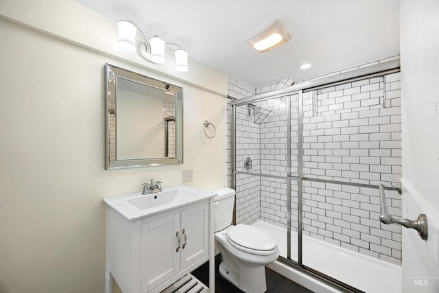 full bath with toilet, a stall shower, and vanity