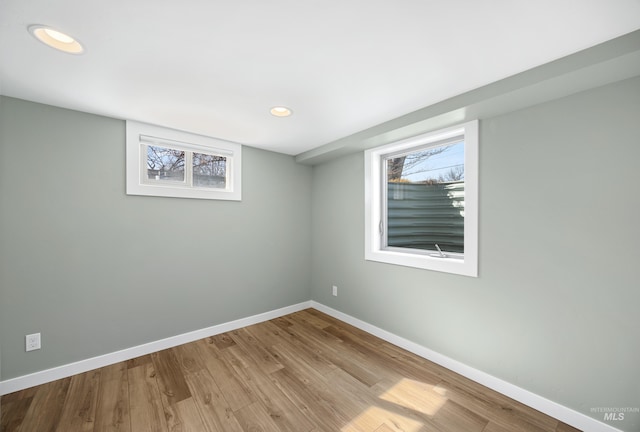 below grade area featuring recessed lighting, baseboards, and wood finished floors