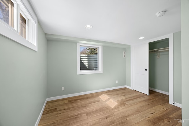 unfurnished bedroom featuring recessed lighting, wood finished floors, and baseboards