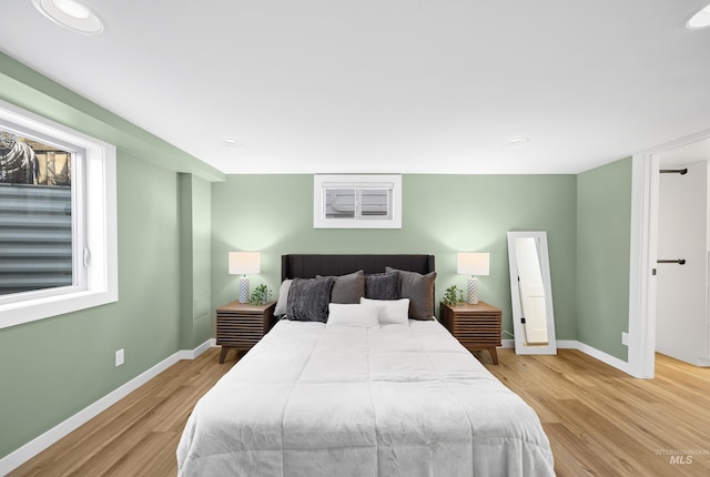 bedroom featuring baseboards and light wood-style floors