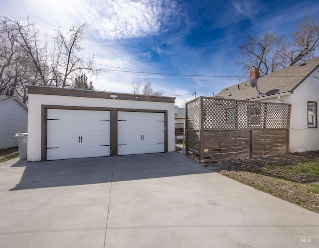 detached garage featuring fence