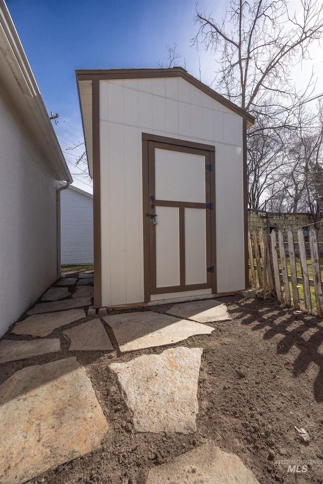 view of shed featuring fence